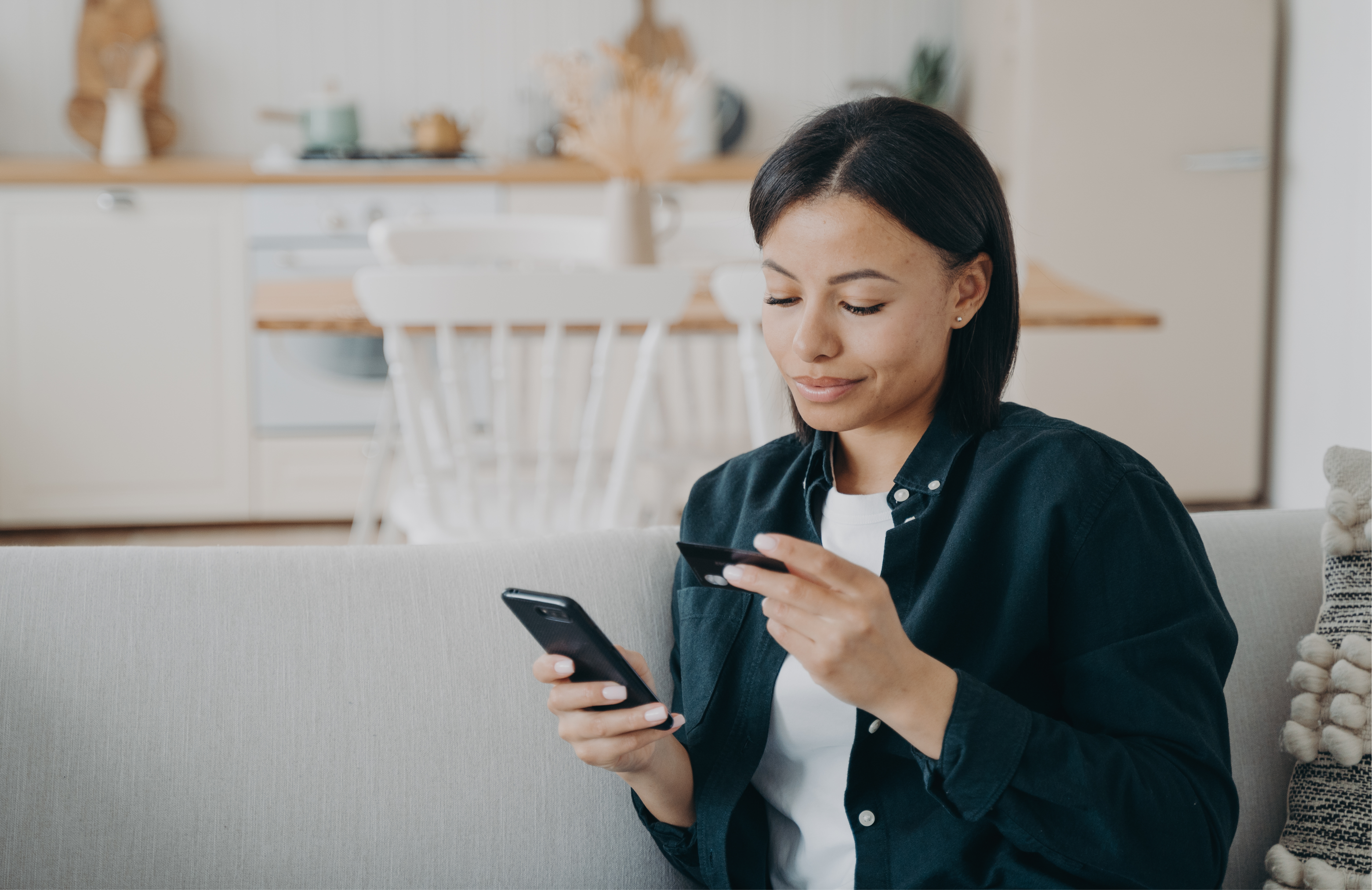 smiling-female-holding-bank-credit-card-smartphon-2023-11-27-05-19-40-utc